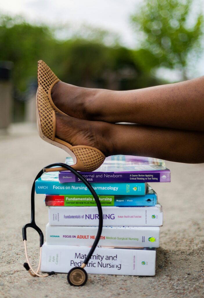 Nurse with feet on nursing books